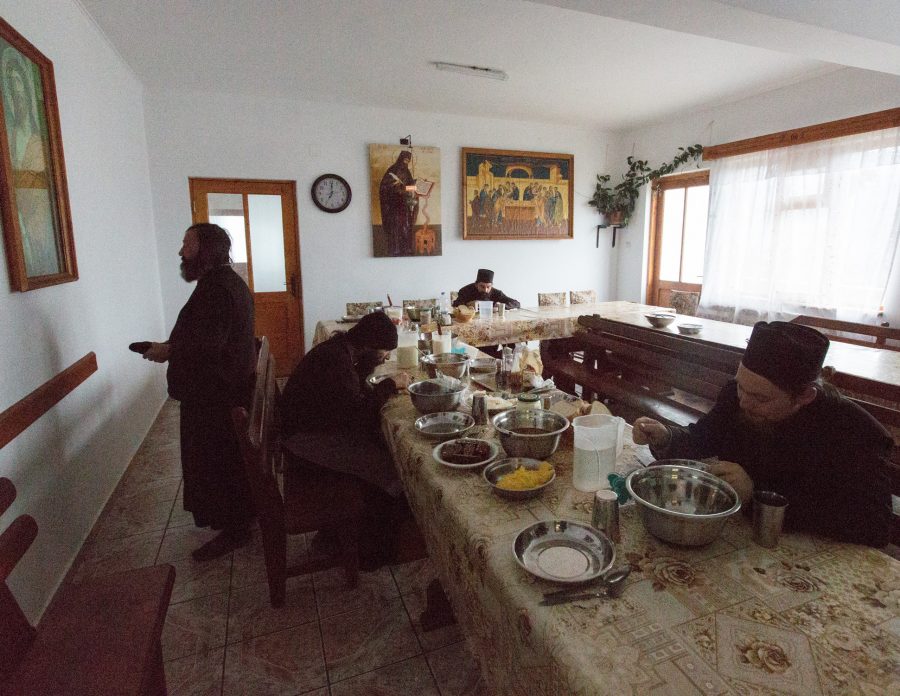 Monks in the monastery of Sf. Ioan Iacob eating and praying.