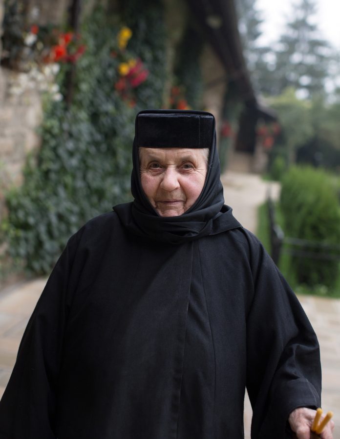 Eastern Orthodox nun in black robe smiling.
