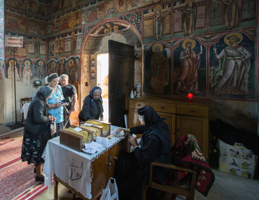 Faithful villagers make their intercession with a nun in the Moldovița nunnery.