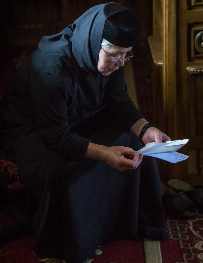 Nun reading a petition in the Moldovița monastery.
