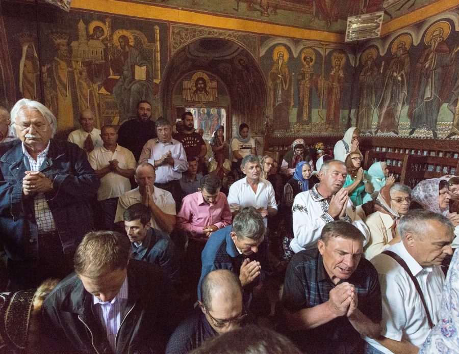 Orthodox Christians praying in a monastery.