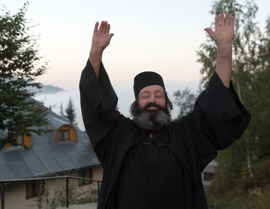 Orthodox monk with his hands in the air.