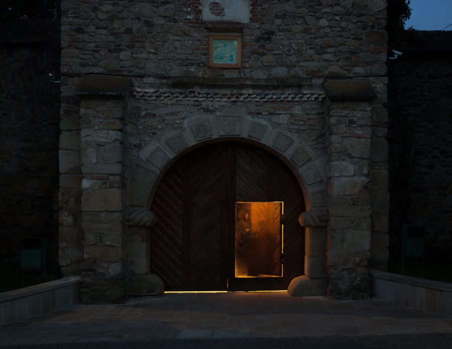 The entrance gate of the Moldovița Monastery at dusk.
