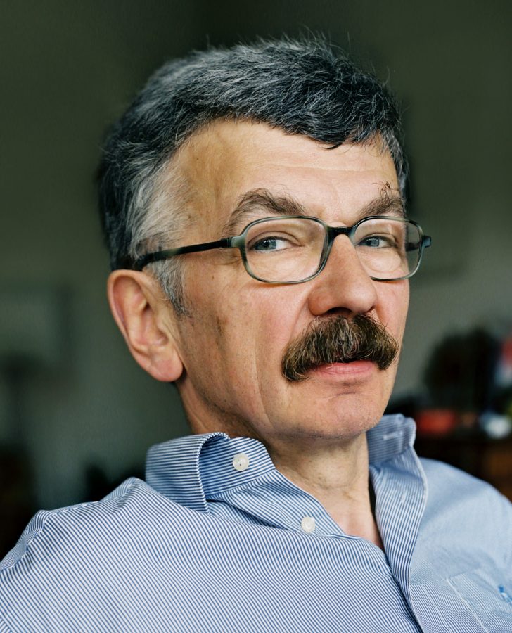 German writer Christoph Hein wearing mustache and glasses.