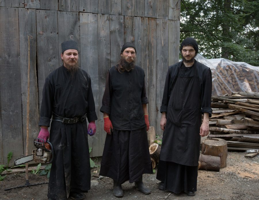 Three monks in the monastery of Sf. Ioan Iacob Corlățeni after cutting the wood.