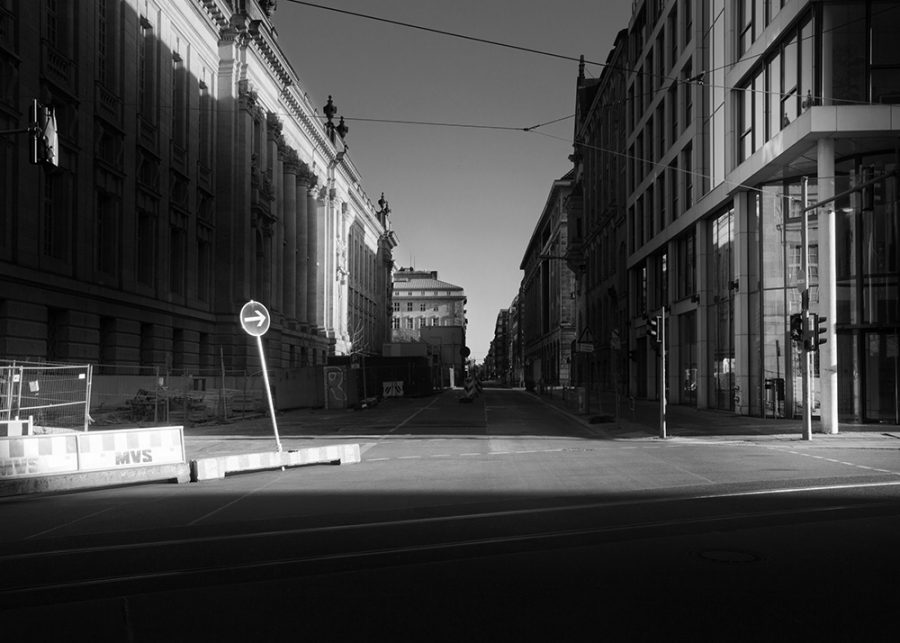 Early morning sun begins to fill empty streets of Berlin with daylight.