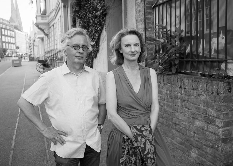 Black and white portrait of Sabine Meyer and Reiner Wehle in the streets of Lübeck.