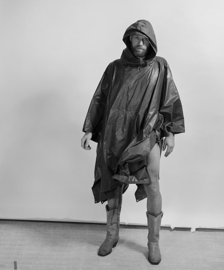 Timo Klöppel wearing a raincoat and boots.