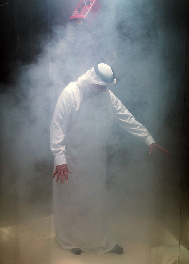 Rashid bin Khalifa Al Khalifa surrounded by fog from a smoke machine.