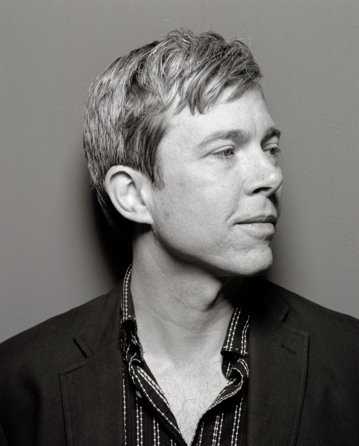 Grey-haired singer-songwriter Bill Callahan in a suit looking to his left.