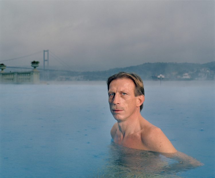 Christoph Daum in the pool of the CIRAGAN PALACE HOTEL KEMPINSKI on the European side of the Bosphorus in the background the bridge that leads to Asia.