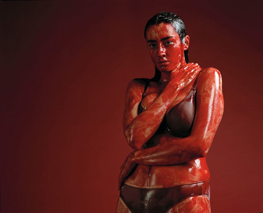 Constanze Becker wearing a underwear is covered in bloodish red paint.