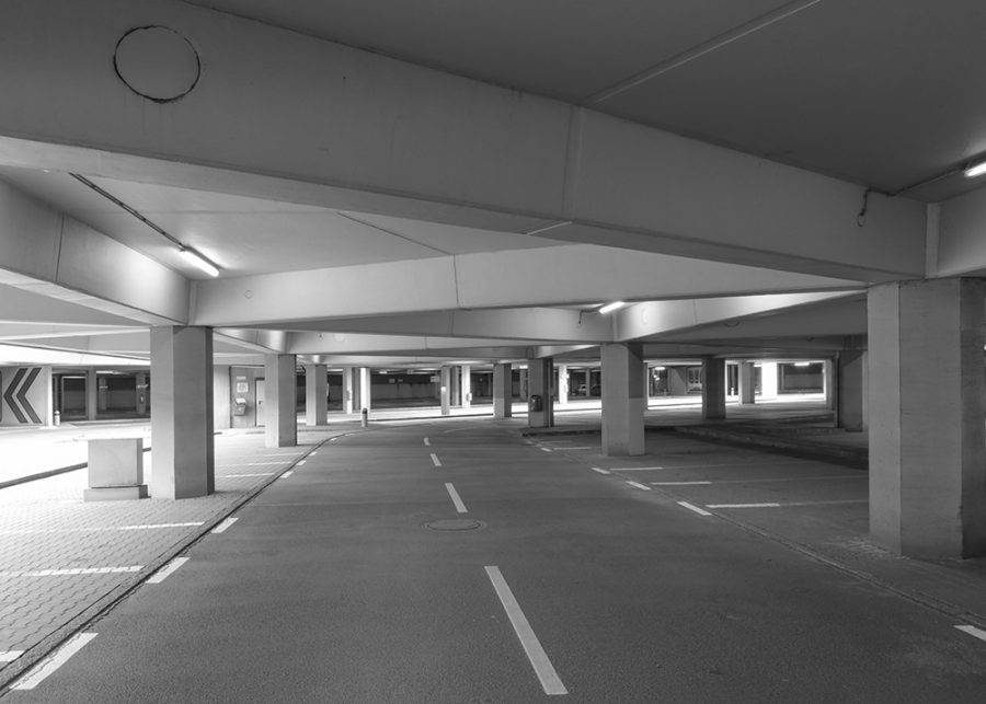 Daylight entering halls of an empty parking lot.