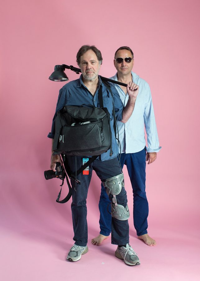 Photographers Hans-Jürgen Burkard and Oliver Mark standing in front of a pink background.