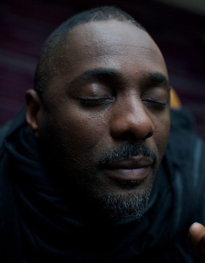 Close-up portrait of untroubled Idris Elba with eyes closed.