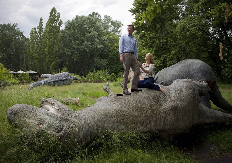 Karl-Theodor zu Guttenberg and his wife on a model of a dinosaur in Berlin Spreepark.