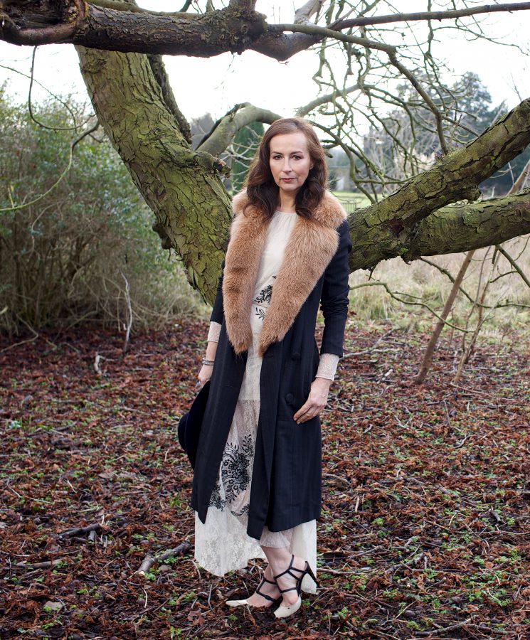 Portrait of the entrepreneur Katharina Flohr wearing a fur coat in her garden in Fairford.