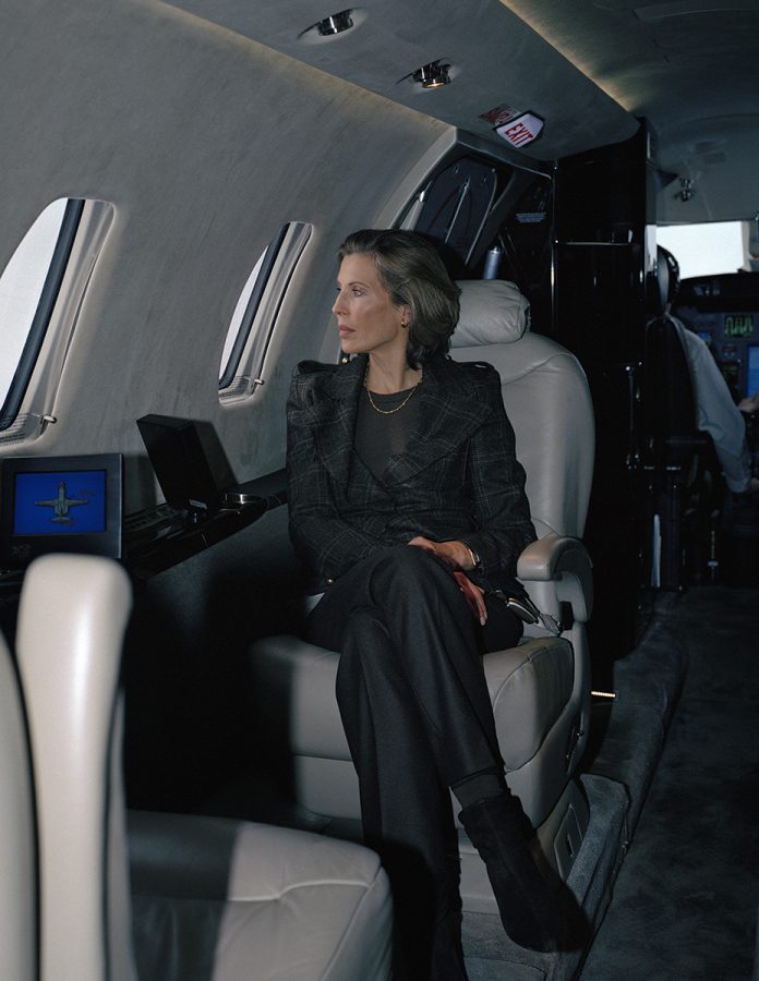 Katrin Bellinger looking out the window as a passanger in a private plane.