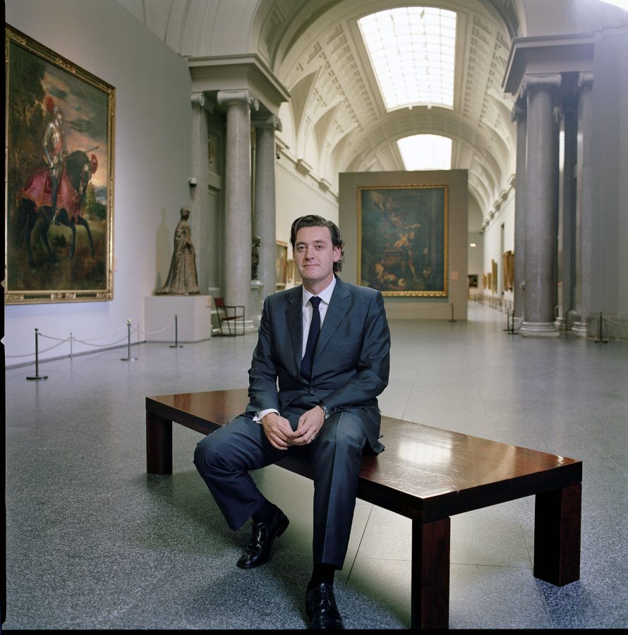Art historian Miguel Zugaza in the Galeria Central of the Prado Madrid in front of the equestrian portrait of Charles V by Titian.