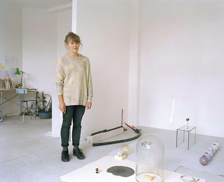 Nina Canell in her sparse studio with minimalistic sculptures and installations in the floor.