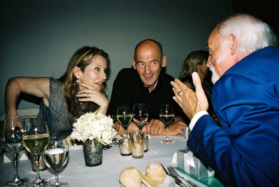 Paola Antonelli, Rem Koolhaas and Ross Lovegrove having a lively conversation with glasses of white whine.