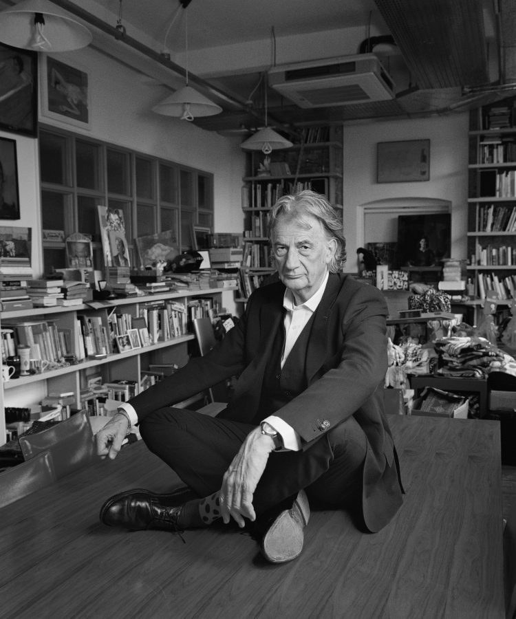 black and white portrait of the designer Paul Smith in his office at 20, Kean Street, London.