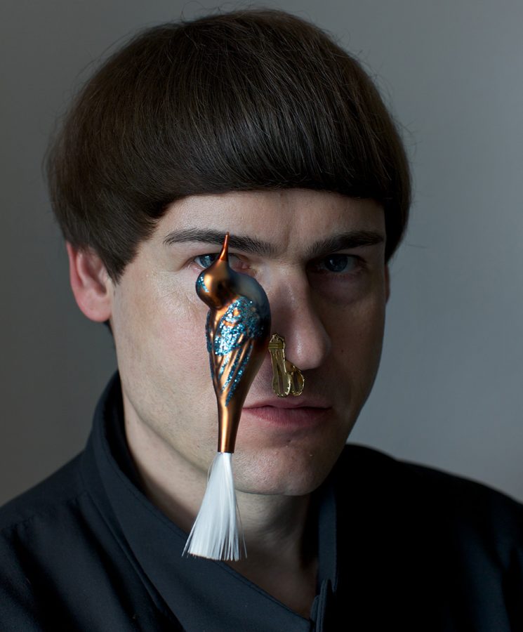 Ralf Ziervogel with a ornamental bird on his nose.