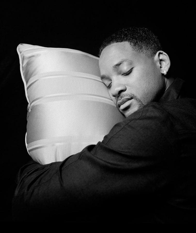 Black and white portrait of Will Smith resting his head on a pillow.