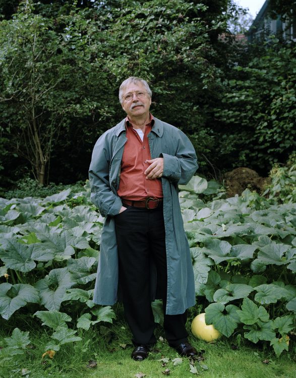 Wolf Biermann in his Hamburg garden in front of a pumpkin patch.