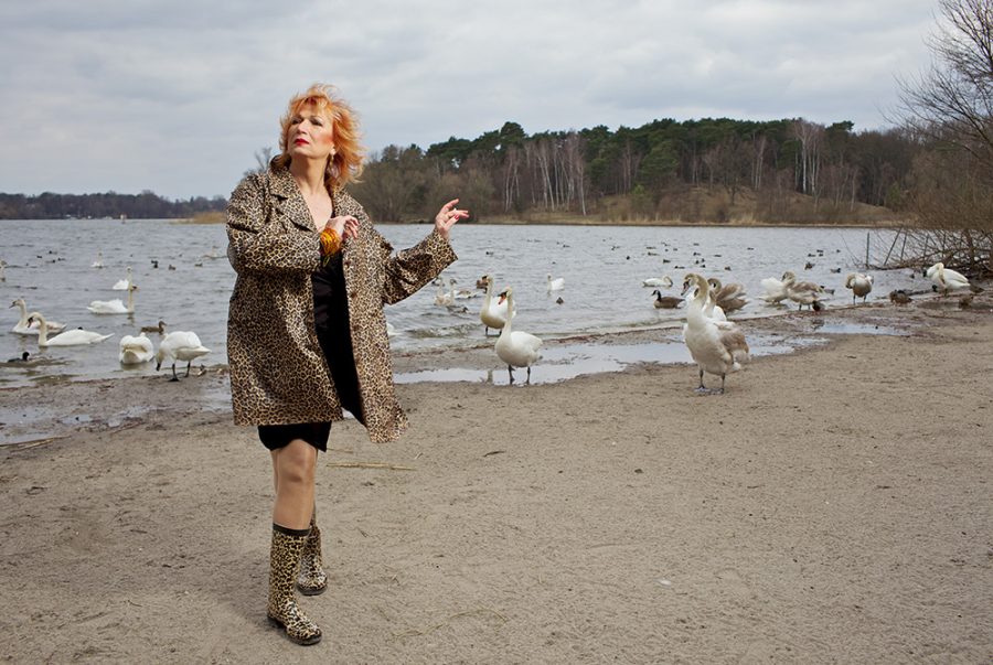 Transsexual actress Zazie de Paris in a leopard dress at Wannsee beach with swans in the background.